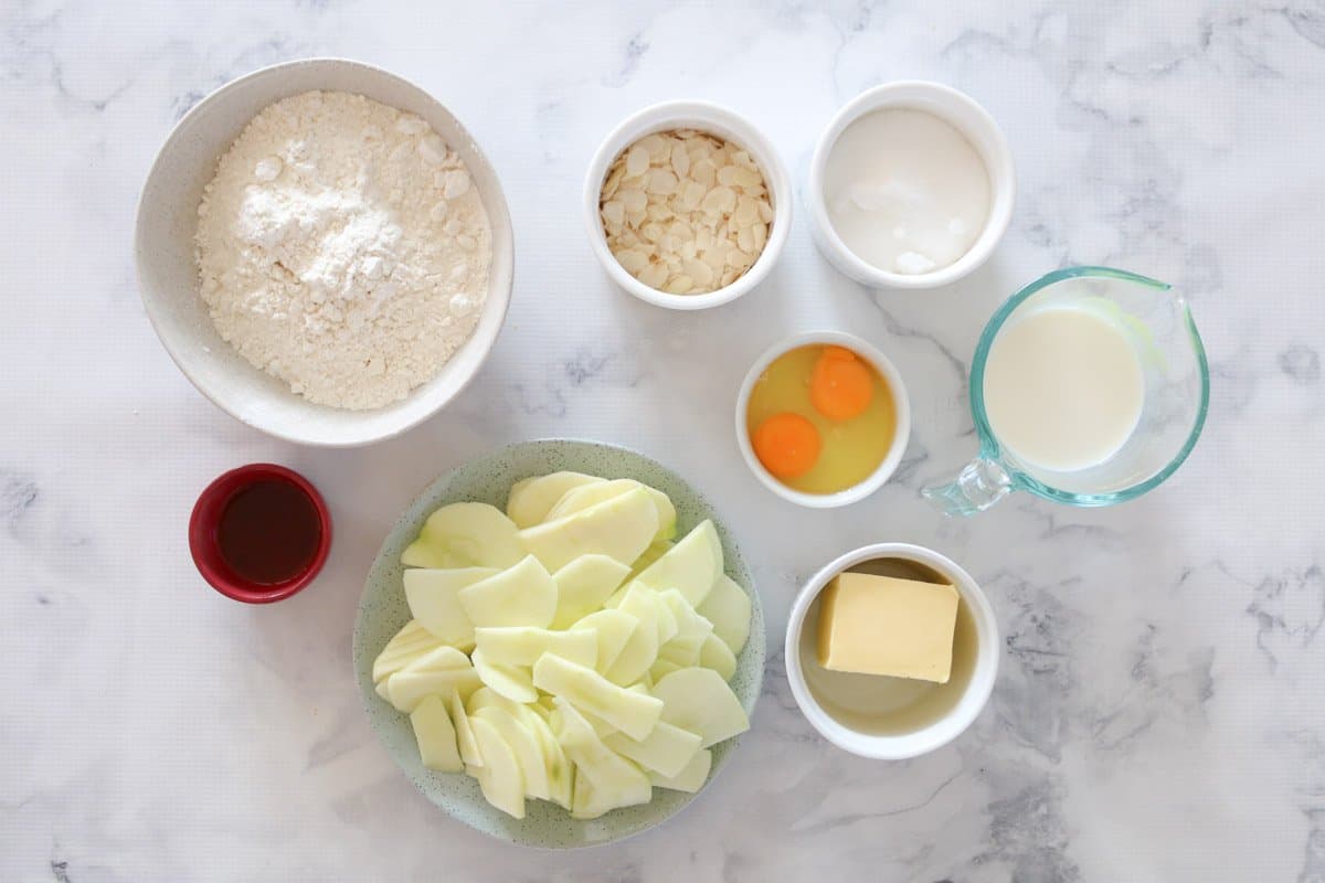 The ingredients for a basic butter cake with sliced apple.
