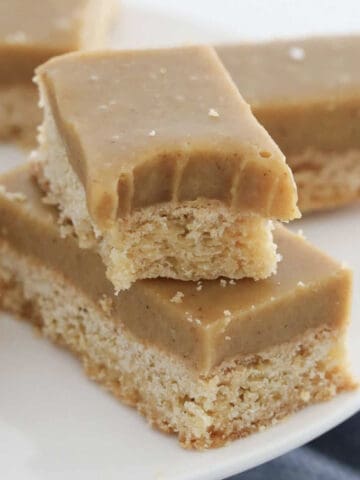 bars of a buttery shortbread slice base with ginger icing.