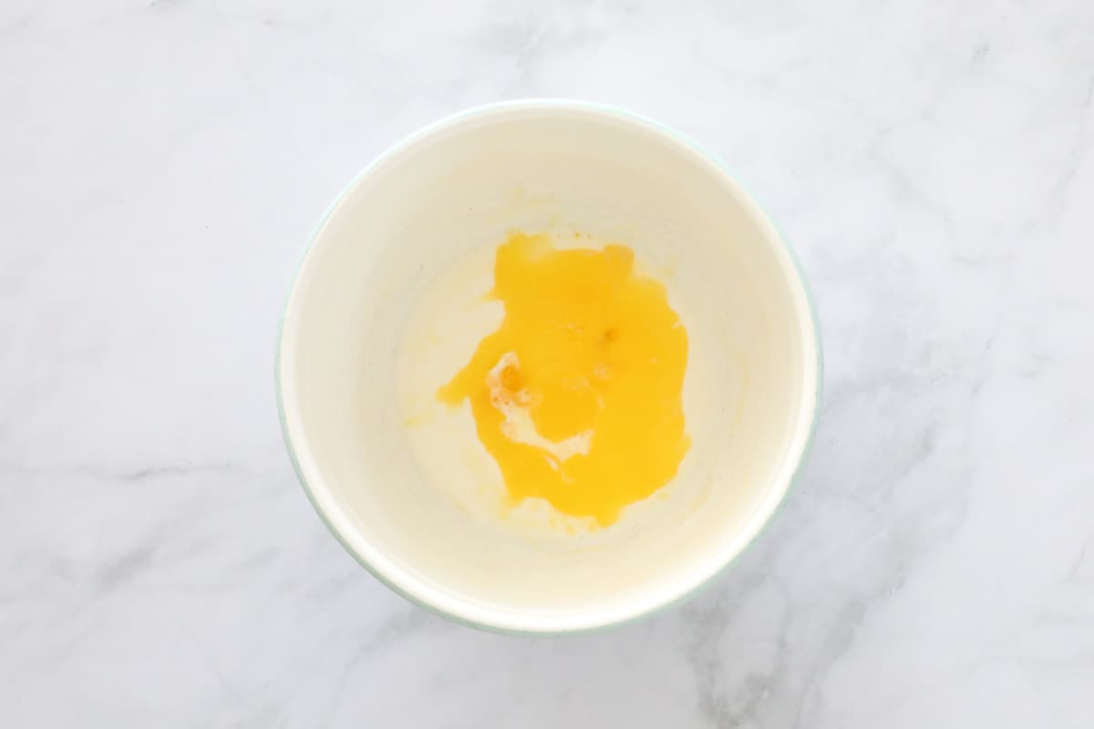Melted butter, milk and egg in a bowl.