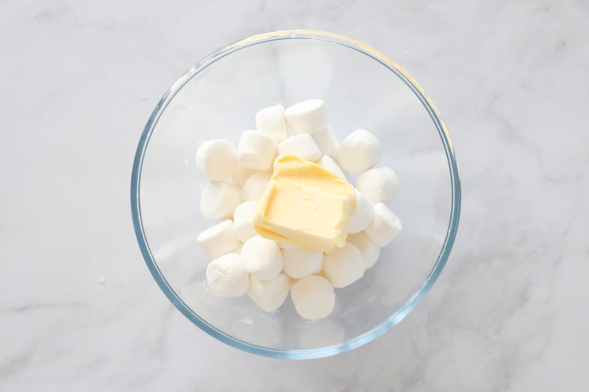 White marshmallows and butter in a bowl.