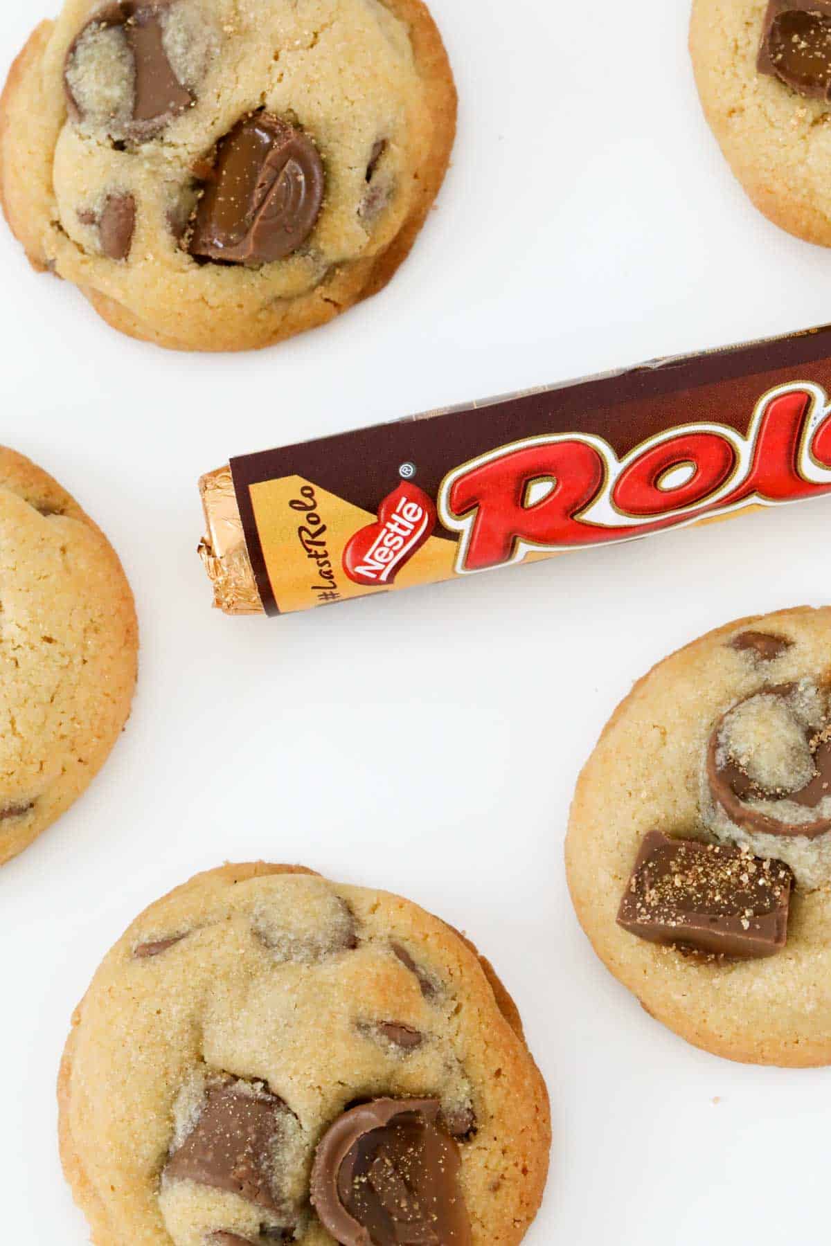 A Rolo chocolate bar next to chocolate chip cookies.