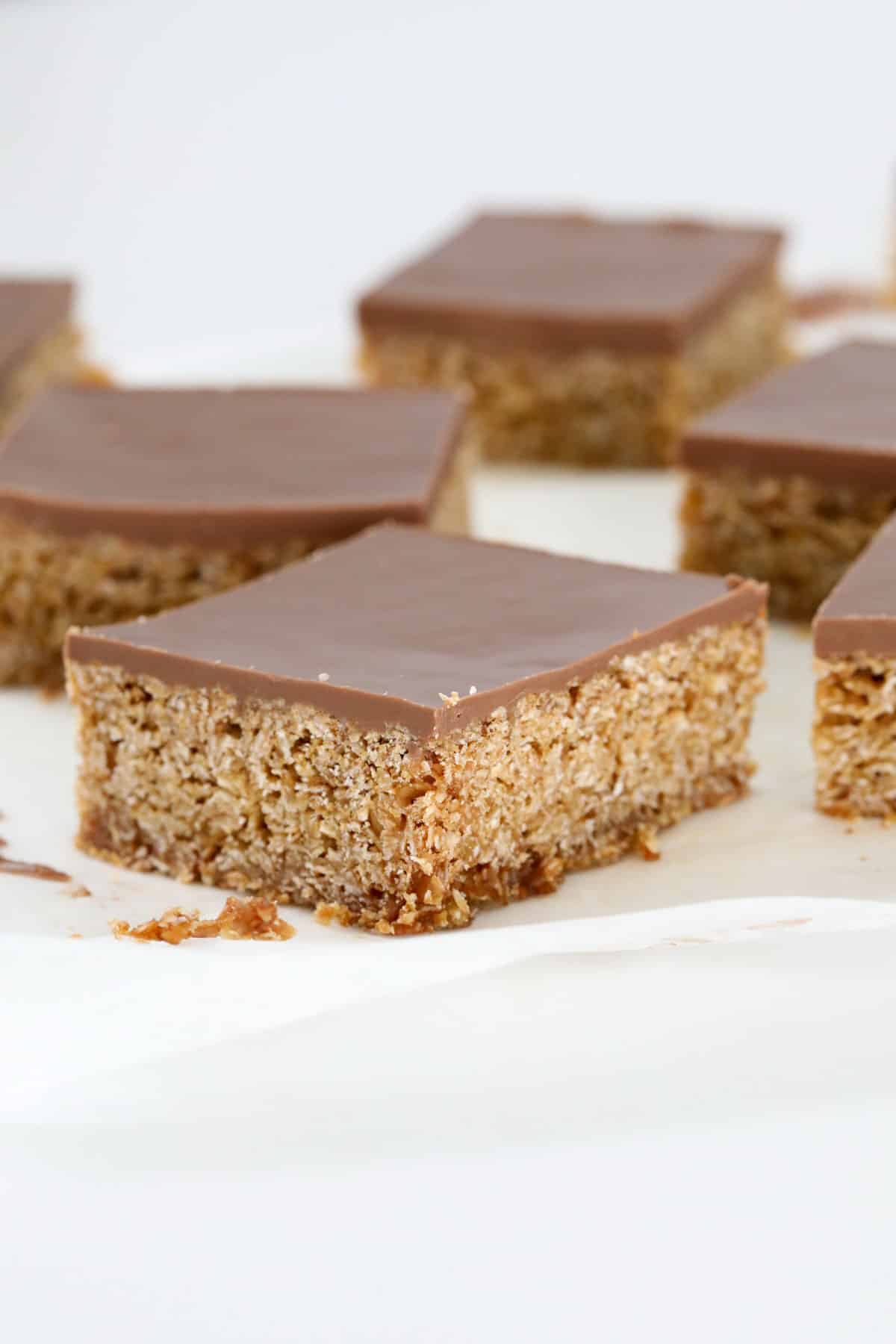 Squares of chocolate flapjacks with chocolate on top.