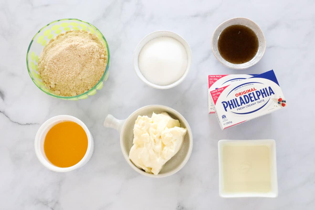 All ingredients for a no-bake cheesecake, laid out on a table.