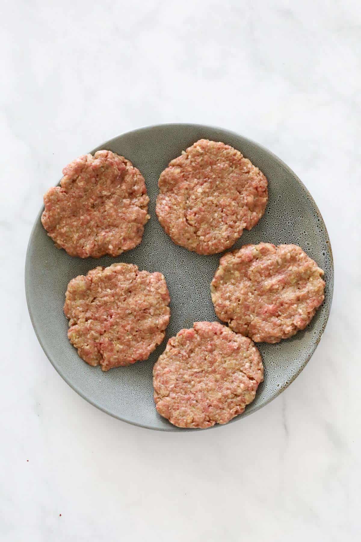 5 formed patties on a plate.