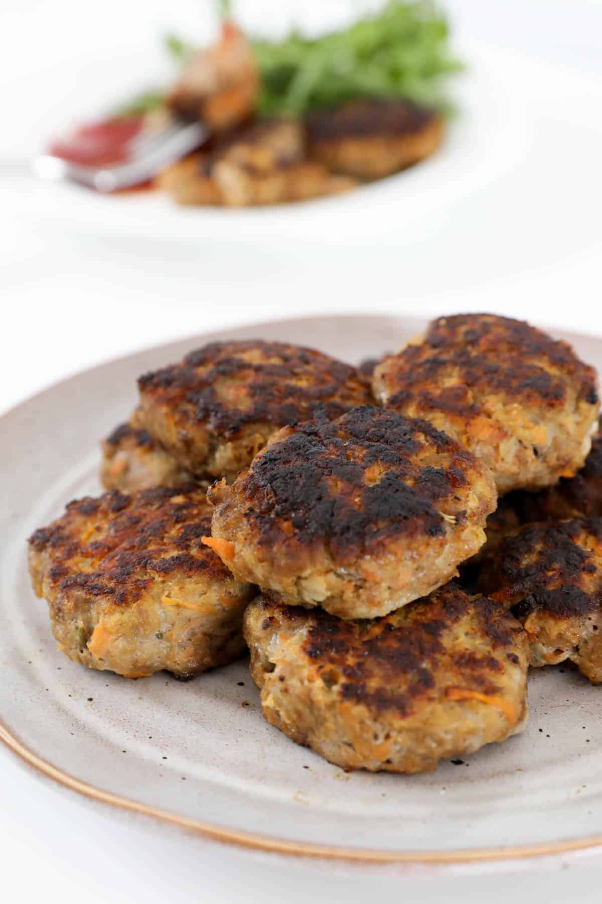 A pile of cooked rissoles on a plate.