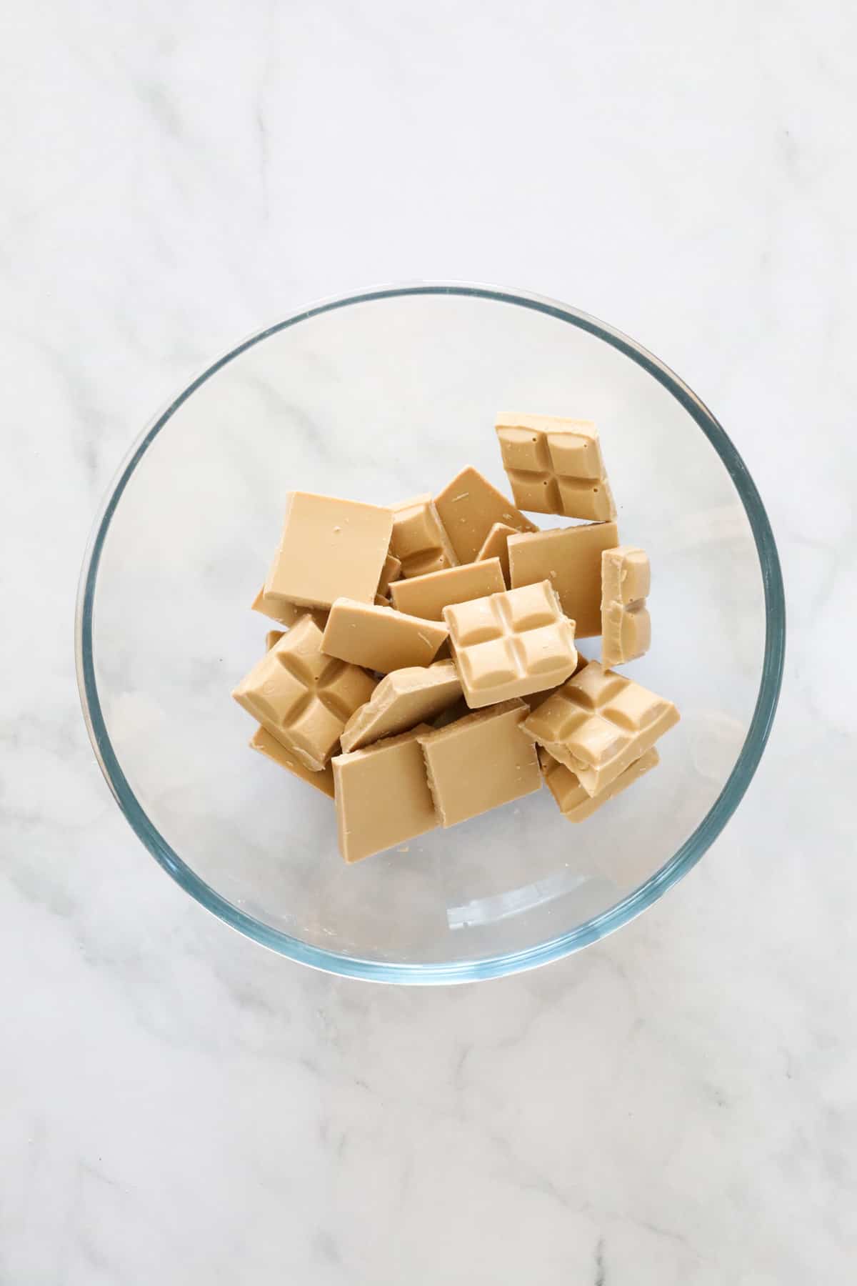 Pieces of Caramilk chocolate in a glass bowl.