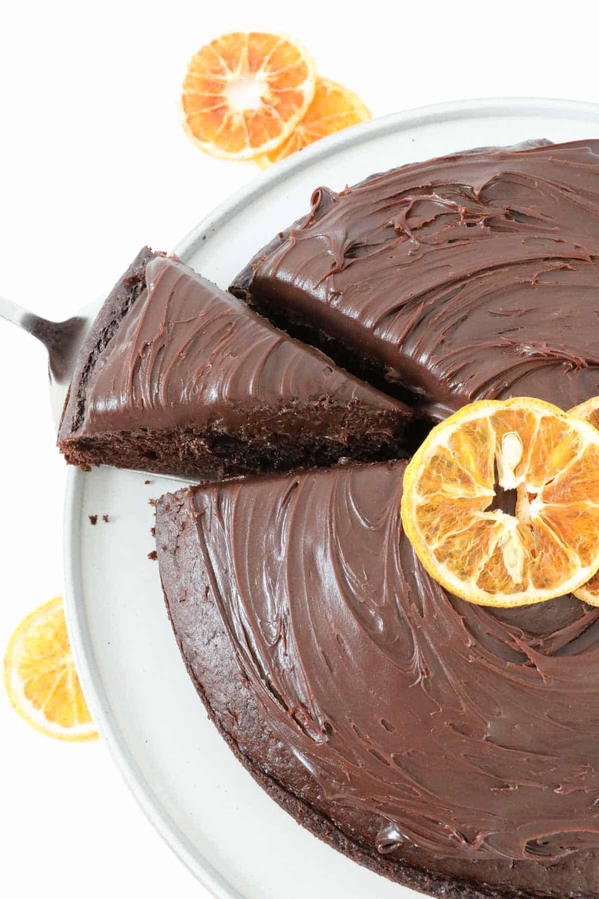 Chocolate orange cake with a slice partly removed..