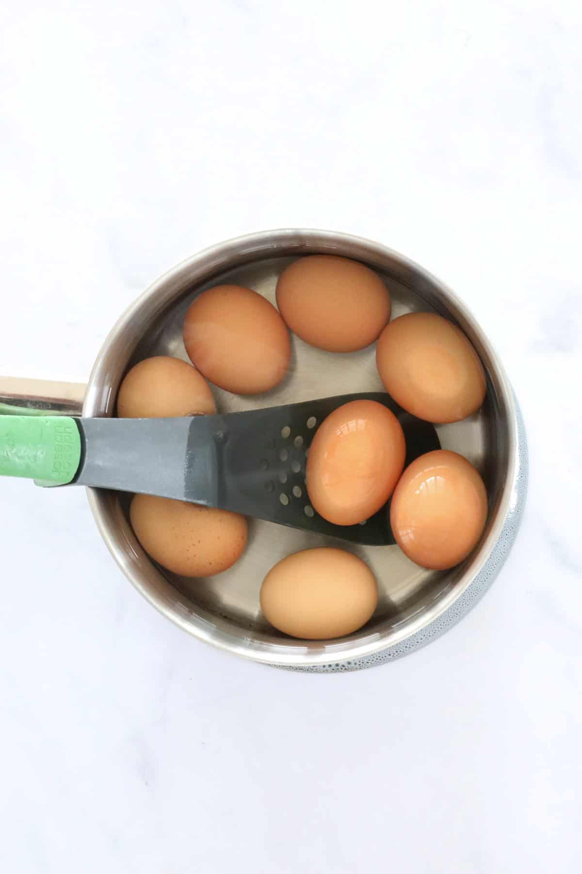 Raw eggs in a pot.