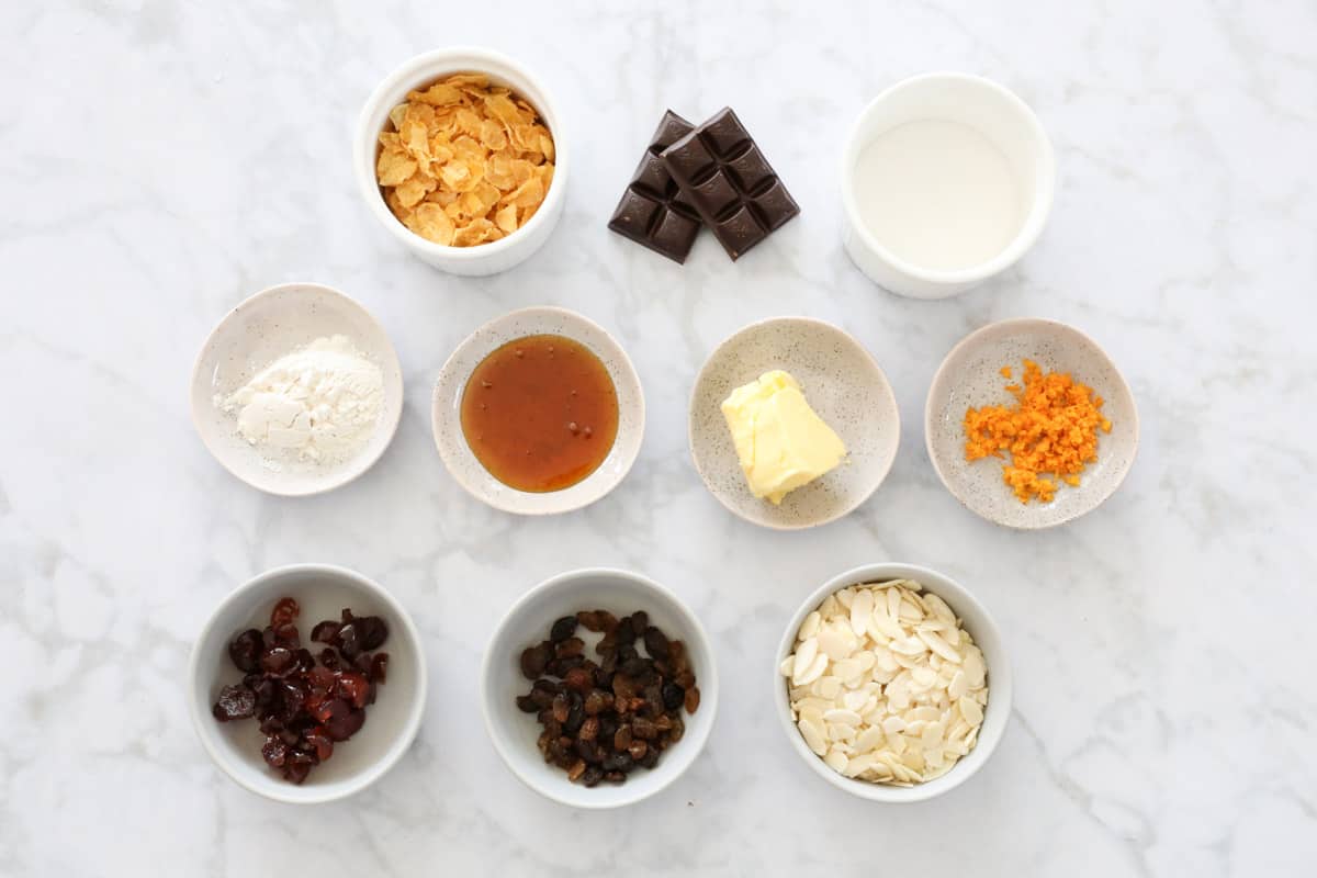 All ingredients for biscuits, laid out in individual bowls on a table.