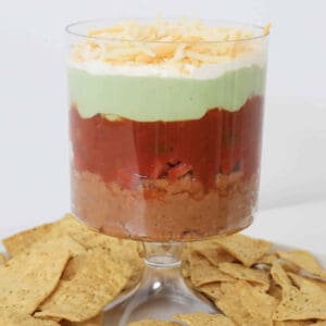 A tall bowl holding a layered dip.