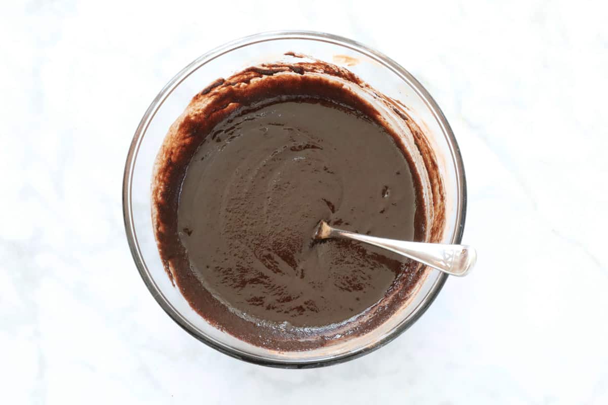 A thick chocolate mixture in a glass bowl.