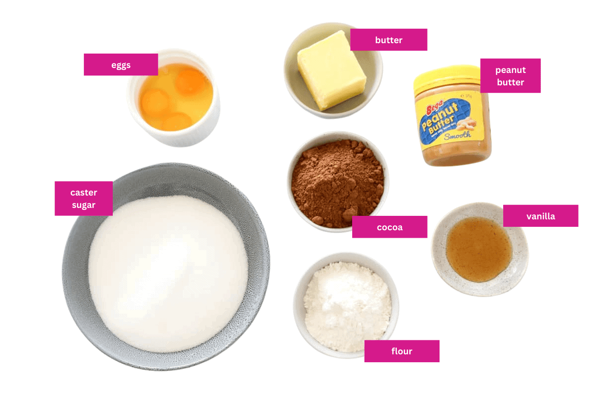The ingredients for peanut butter brownies laid out in small bowls.