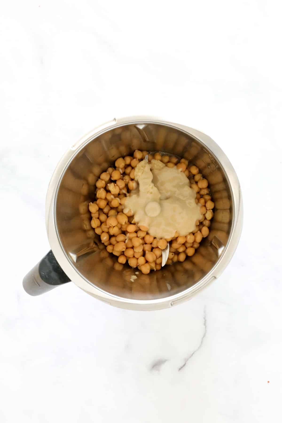 Chickpeas and tahini in a Thermomix bowl.