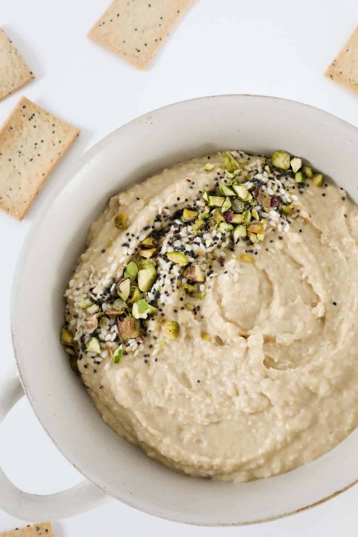 Pistachios, sesame seeds and poppy seeds, sprinkled on top of a creamy dip.