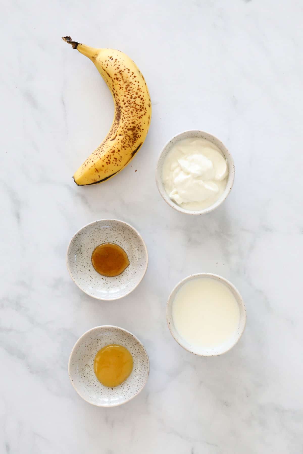 Ingredients for making a banana smoothie.