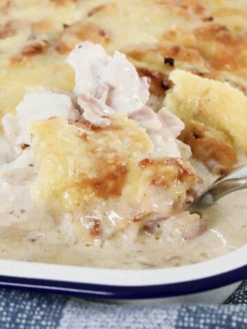 A casserole of creamy chicken and bacon with ranch dressing in a baking dish.