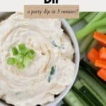 Carrot, celery and cucumber sticks around a bowl of cream cheese dip.