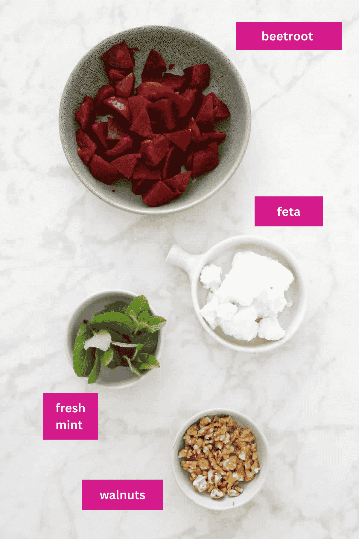Beetroot, mint leaves, feta and walnuts in a bowl.