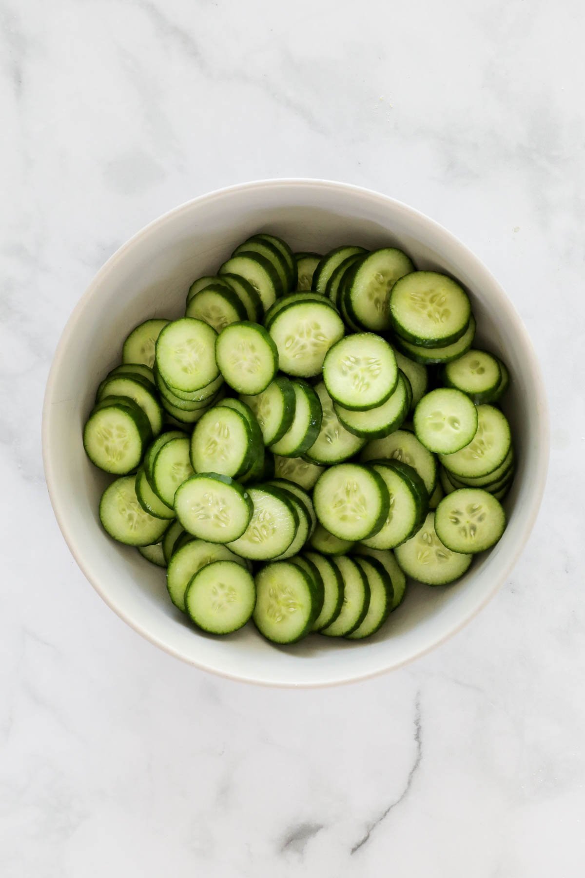 Sliced cucumbers in a bowl.