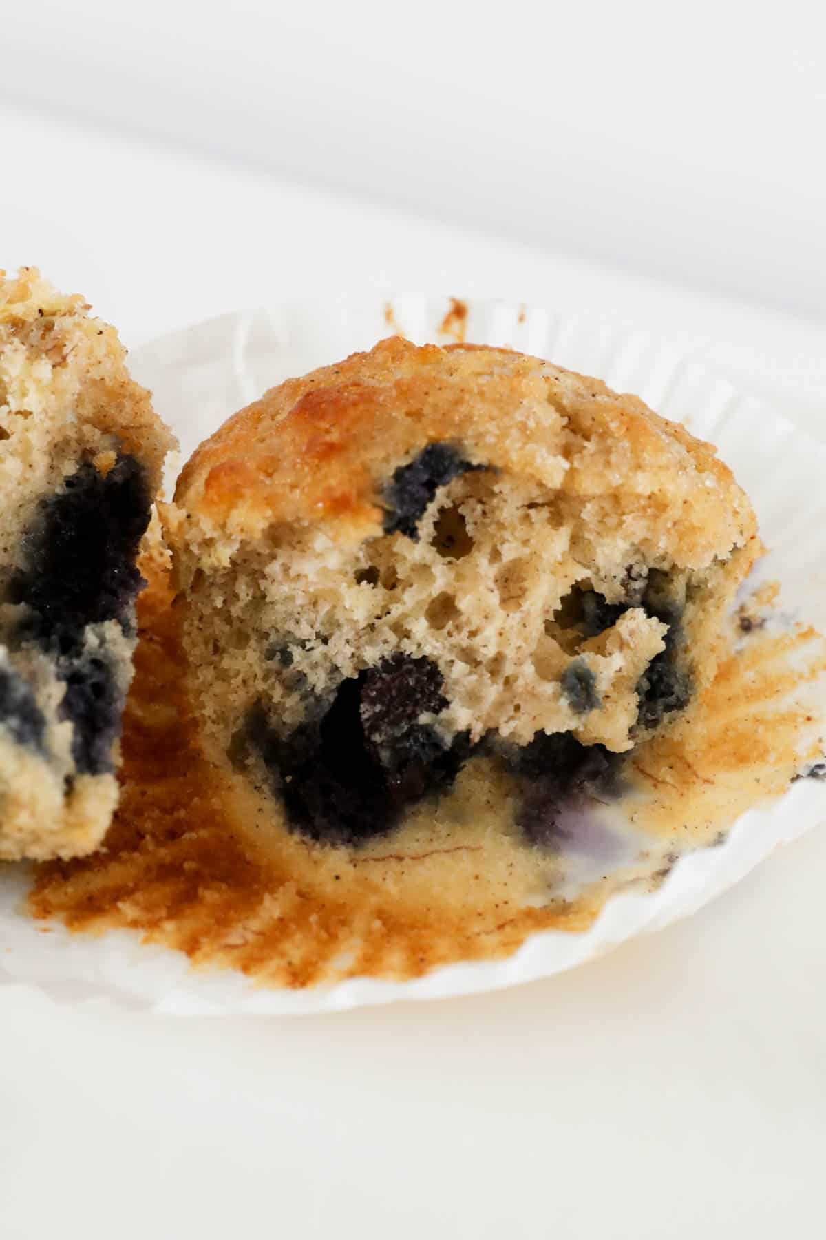 Banana blueberry muffin in a muffin liner.