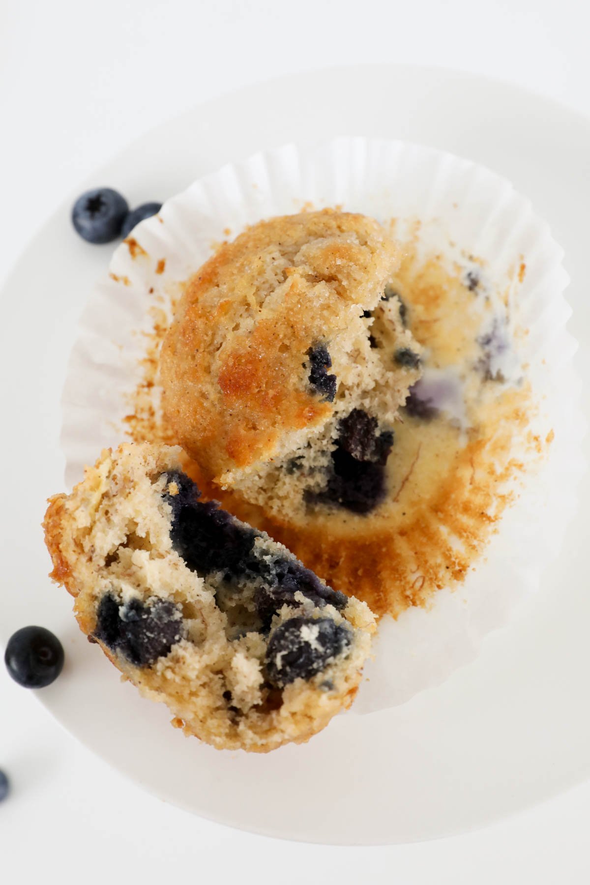 Banana blueberry muffin in a muffin liner.