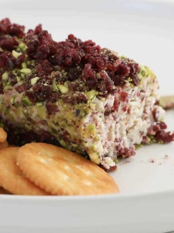 A cheese log with pistachios and cranberries.