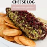 A cream cheese log coated in chopped pistachios and cranberries.