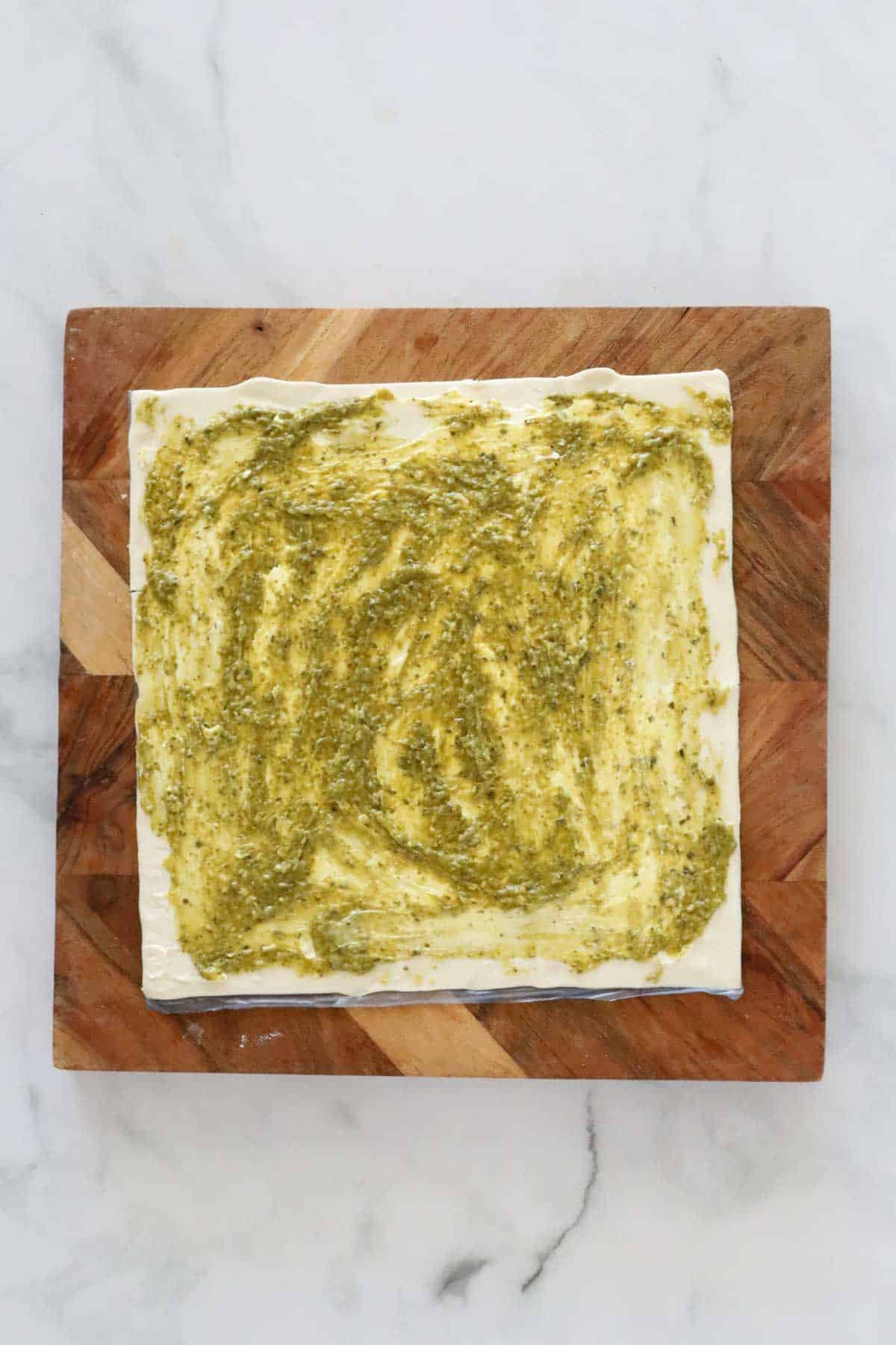Pesto and cream cheese spread on a puff pastry.