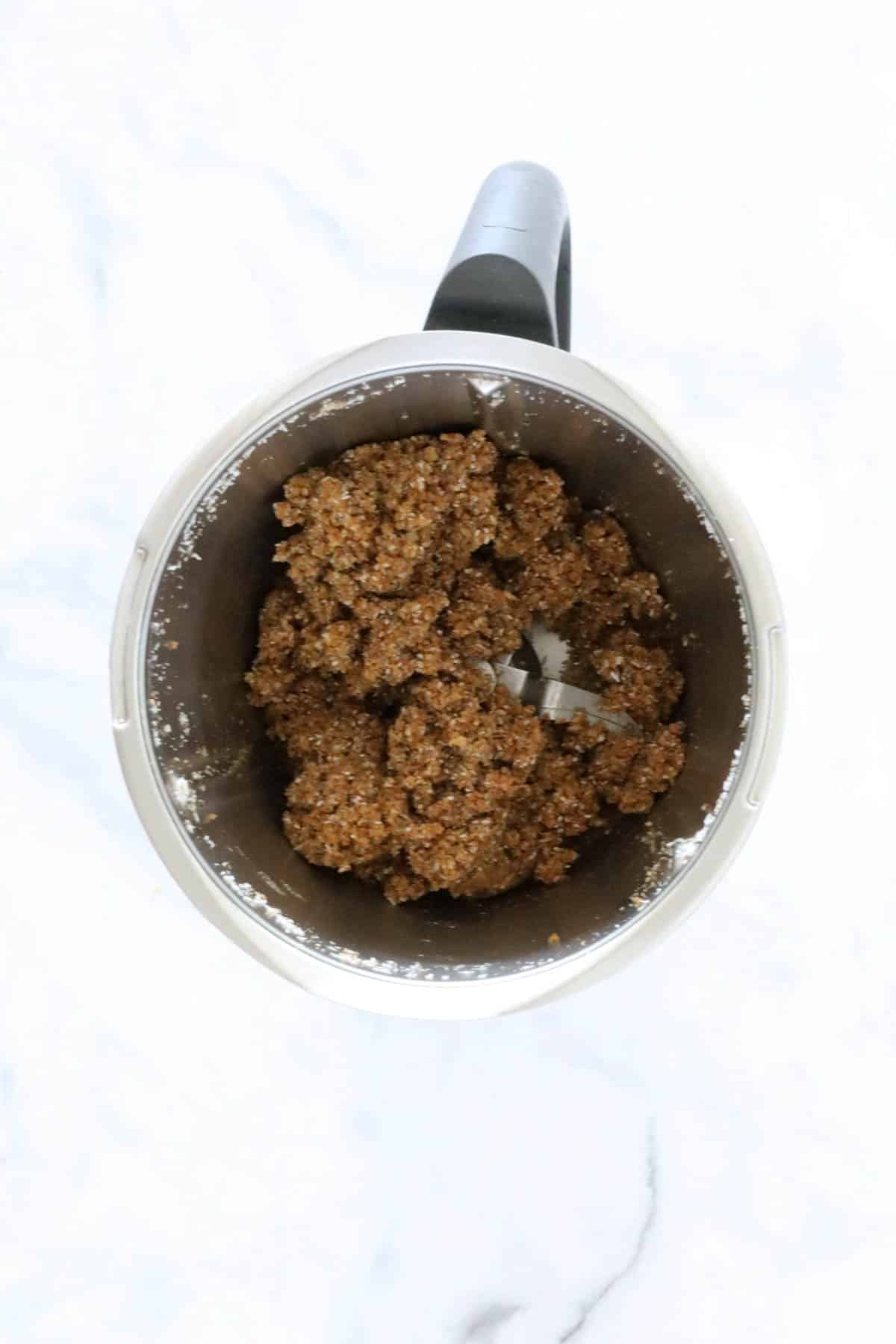 A crumbly mixture in a Thermomix jug.