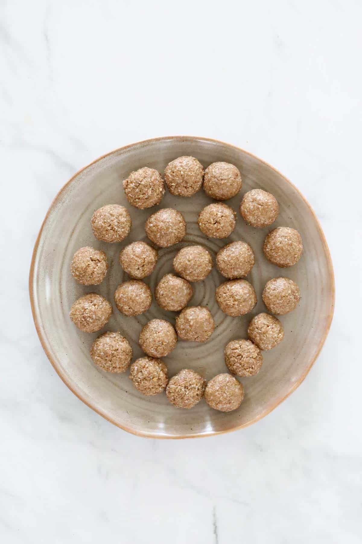 Small rolled kids protein balls on a plate.