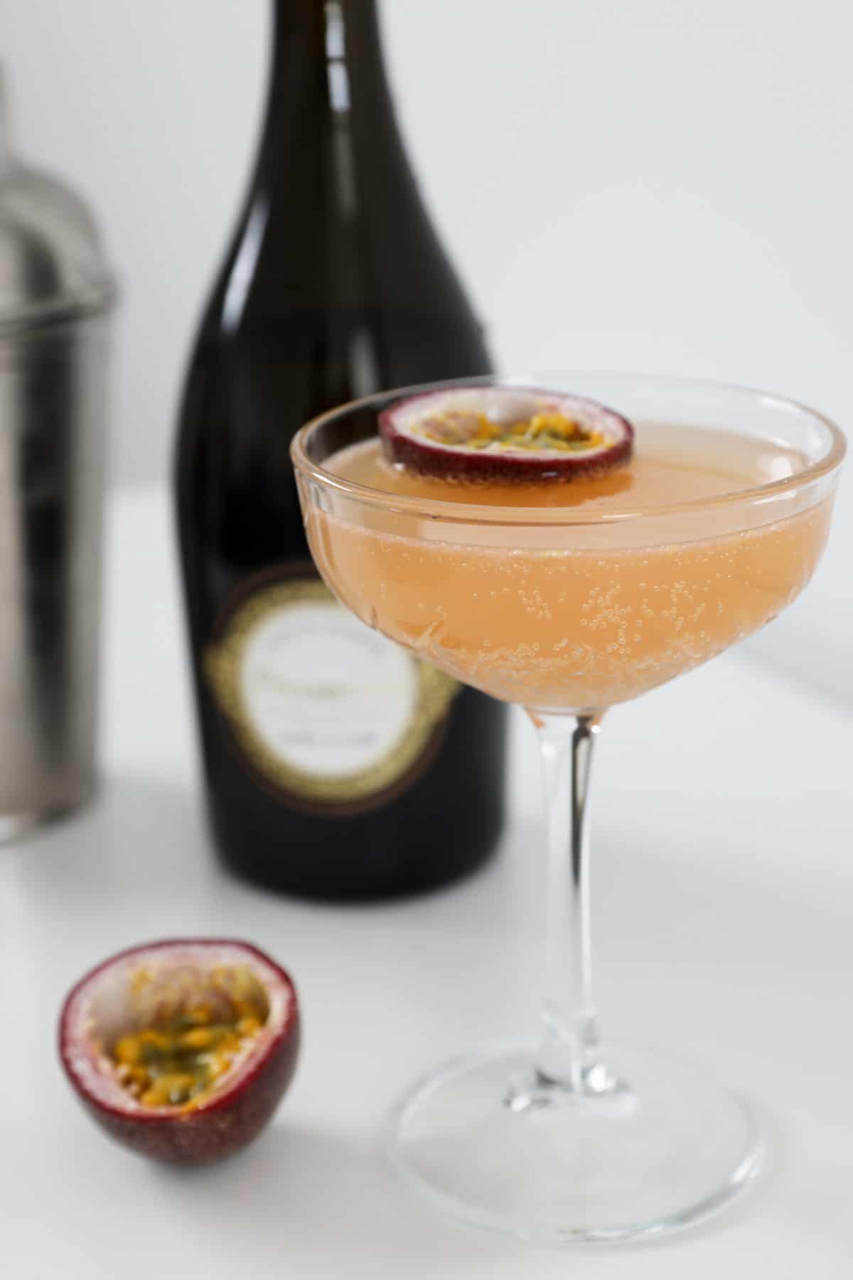 A passionfruit cocktail garnished with fresh passionfruit.