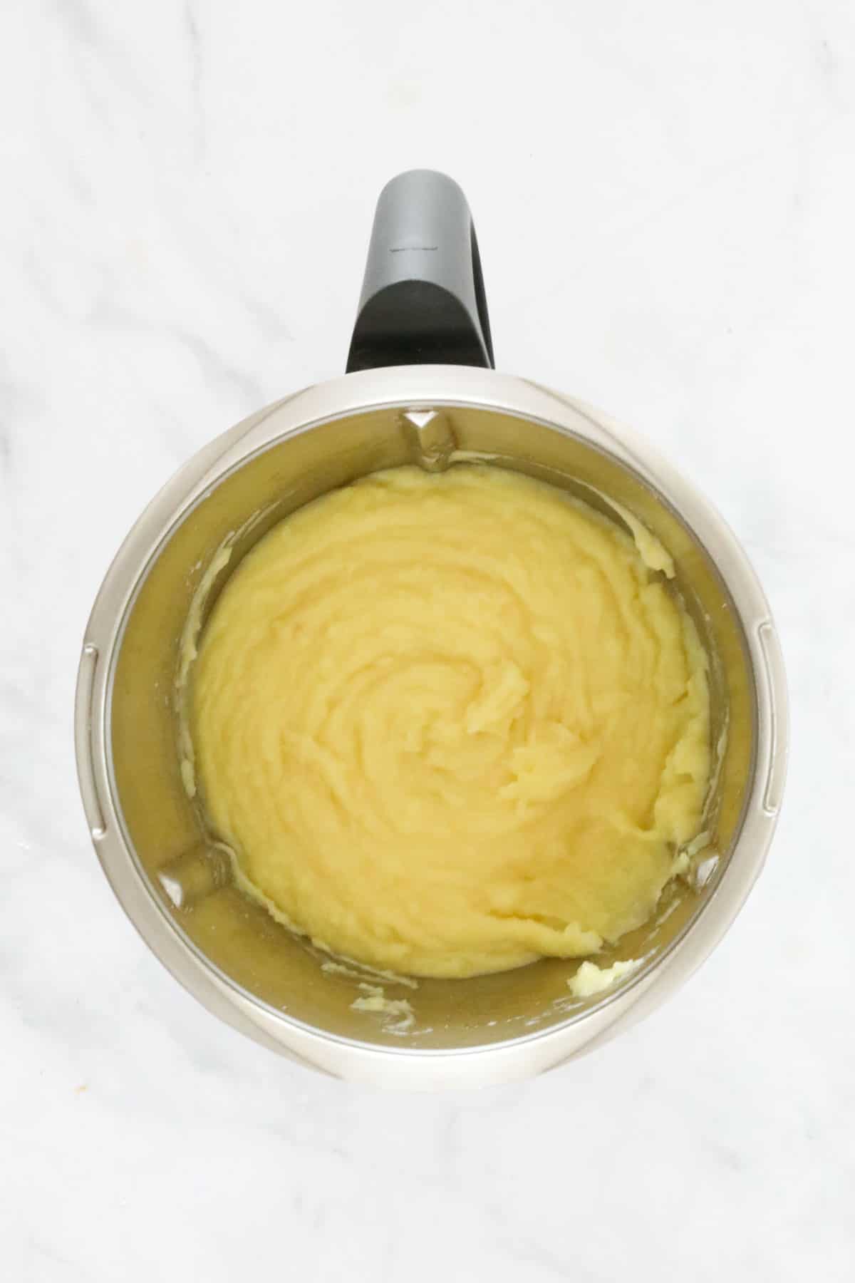Creamy potatoes in a stainless Thermomix bowl.