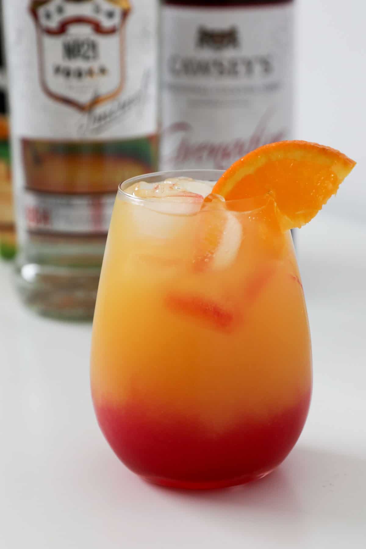 An orange slice in a tropical orange cocktail.
