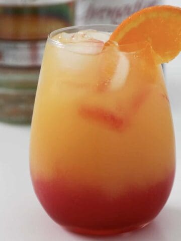 A tropical cocktail with an orange slice.