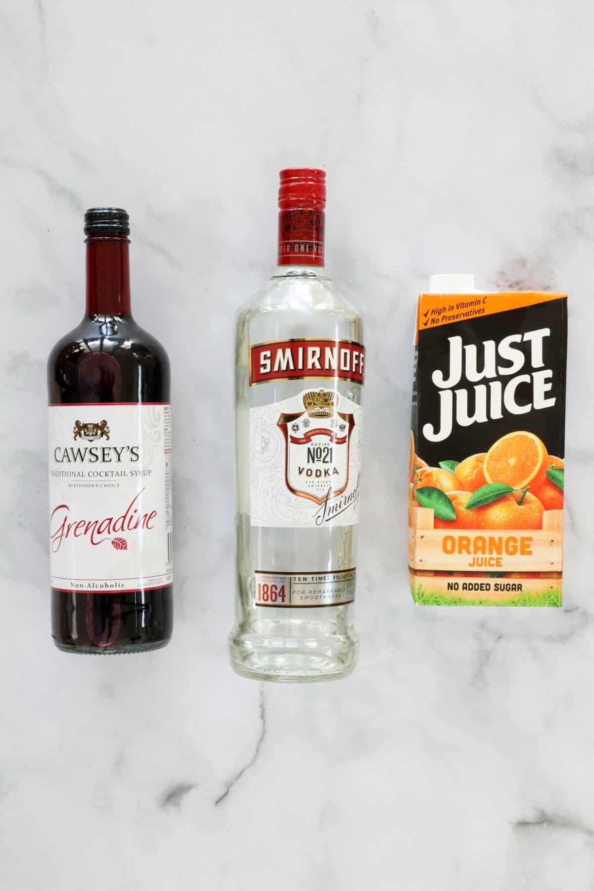 The three ingredients for a vodka sunrise cocktail.