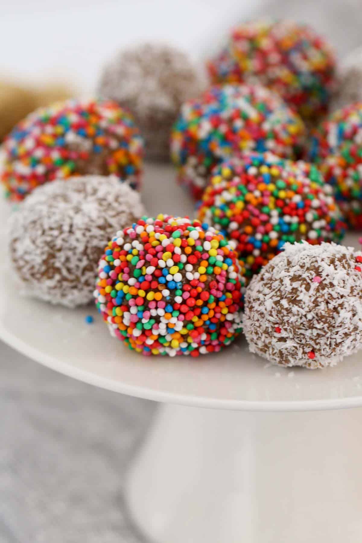 A close up of Milo balls covered in sprinkles and coconut.