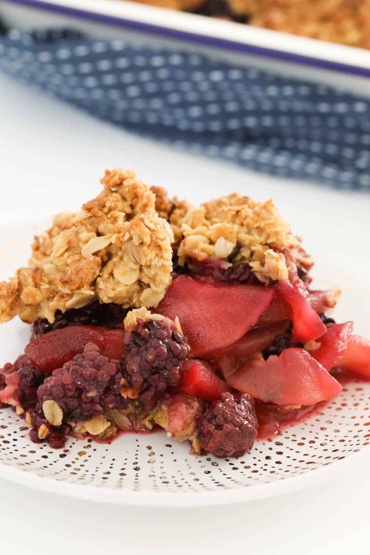 Blackberry and apple crumble on a plate.