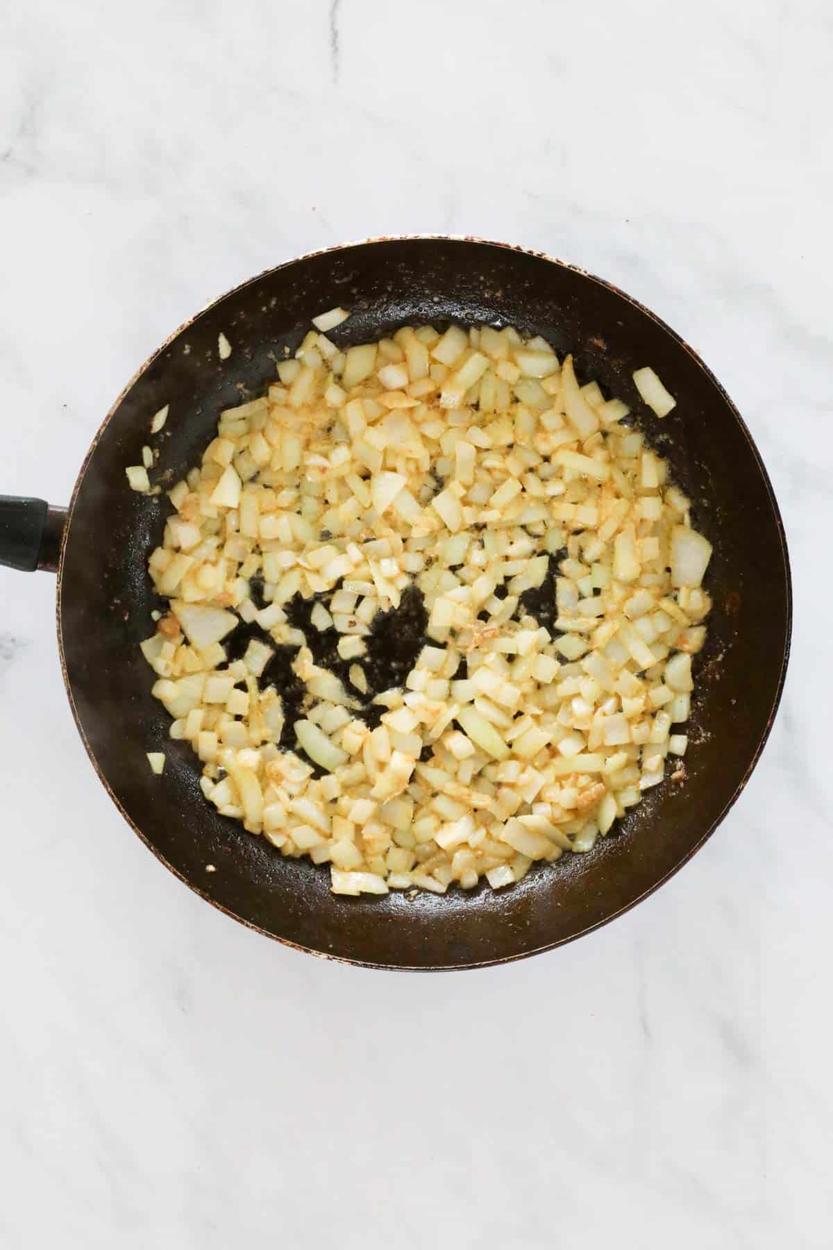 Diced onion browned in a frying pan.