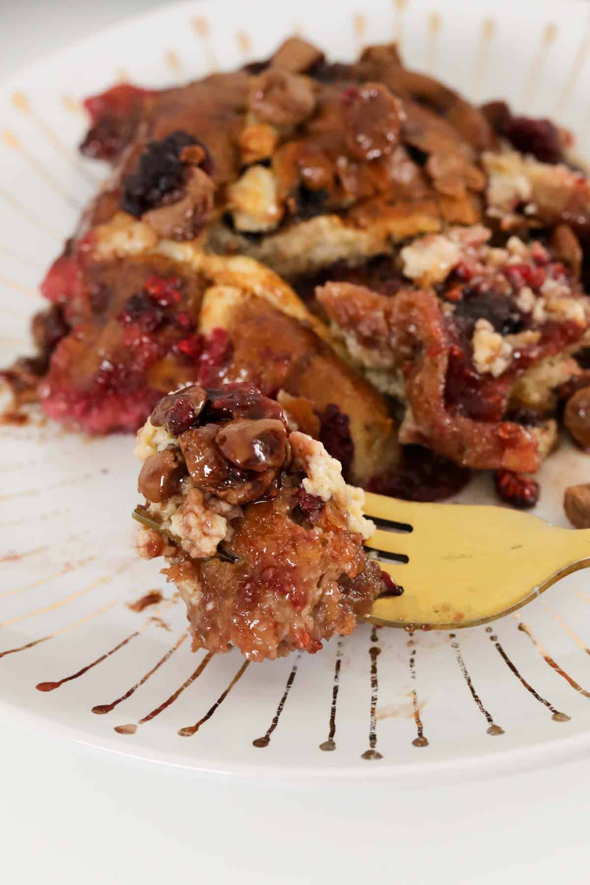 A hot cross bun baked pudding on a fork.