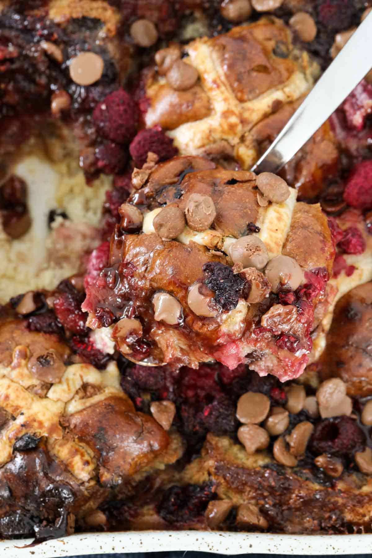 Chocolate and raspberries on top of hot cross bun pudding.