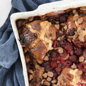 An overhead shot of raspberries and chocolate chips in a bread pudding.