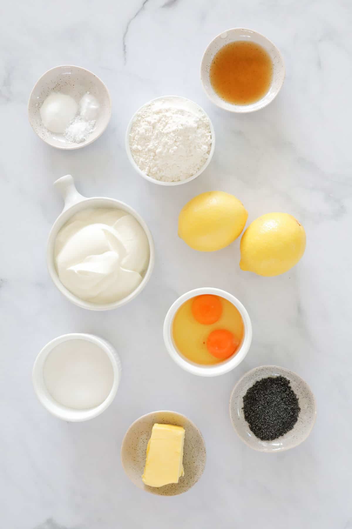 The ingredients needed to make lemon poppy seed muffins.