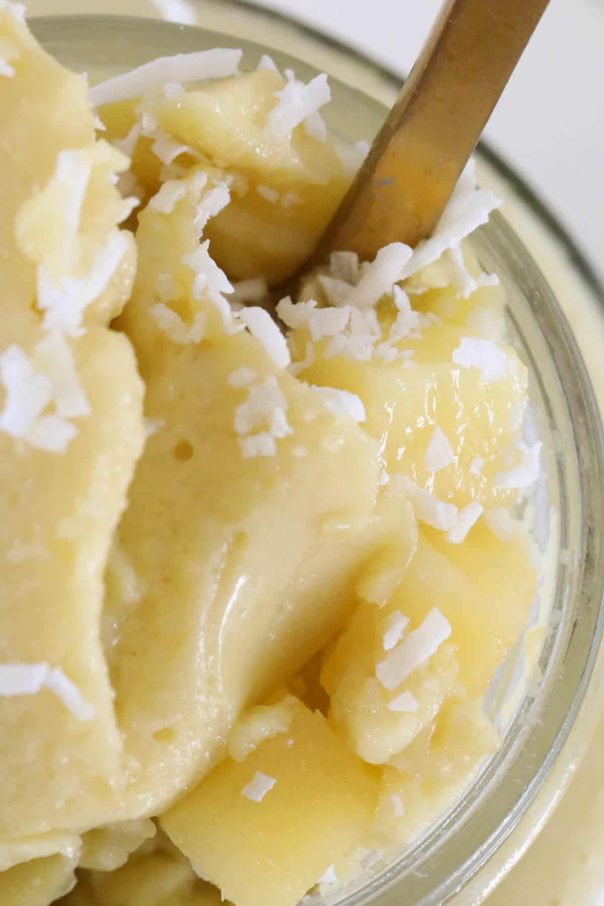 A close up view of mango pudding in a jar.