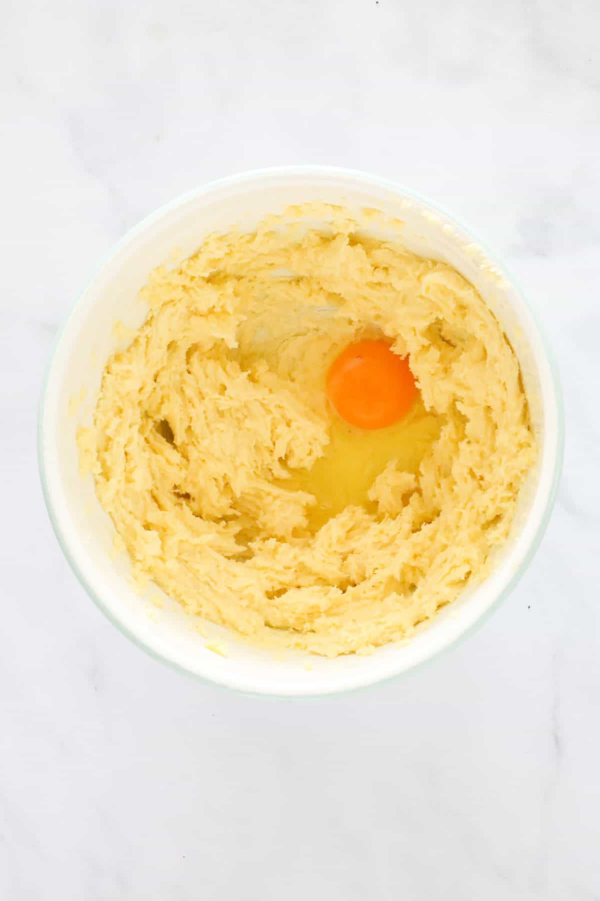 An egg added to creamed butter and sugar.