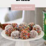 Milo Balls on a cake stand, with some rolled in sprinkles and some in coconut.