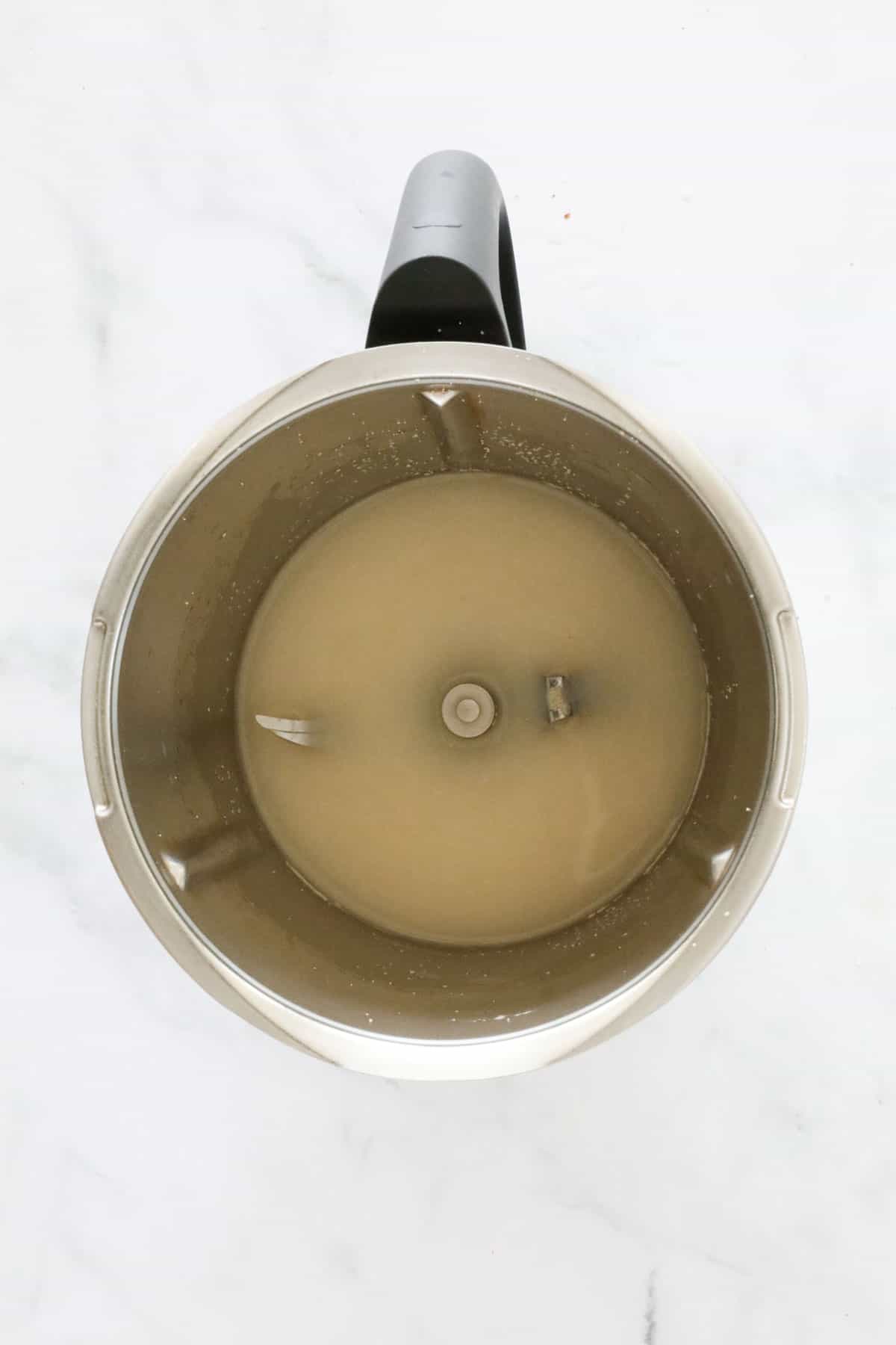 Yeast and water in a stainless jug.