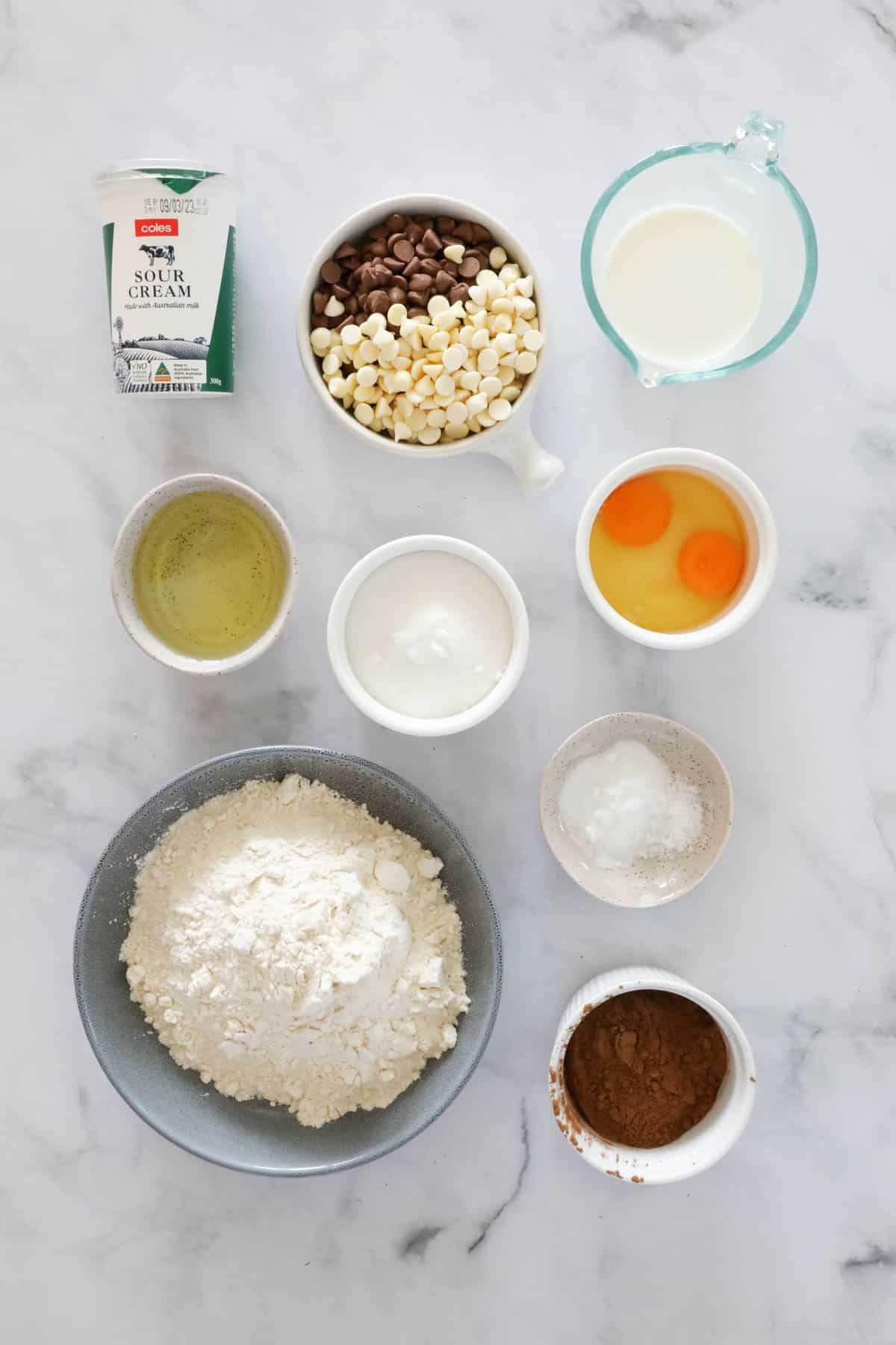 Ingredients for triple chocolate muffins weighed and placed in individual bowls.