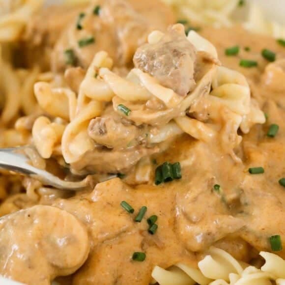 A bowl of creamy beef and mushroom stroganoff, served over egg noodles.