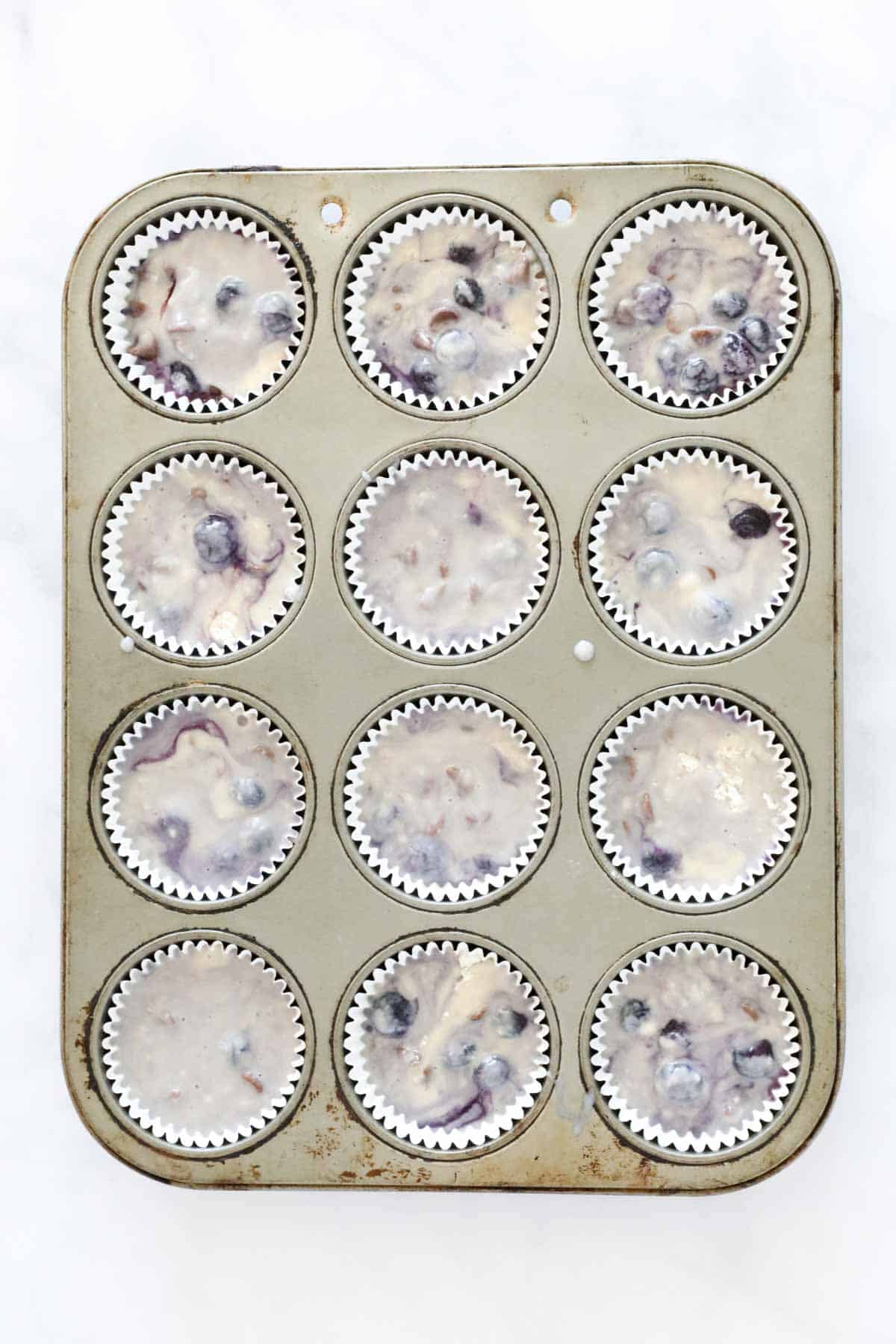 Muffin batter in cases a muffin tin.