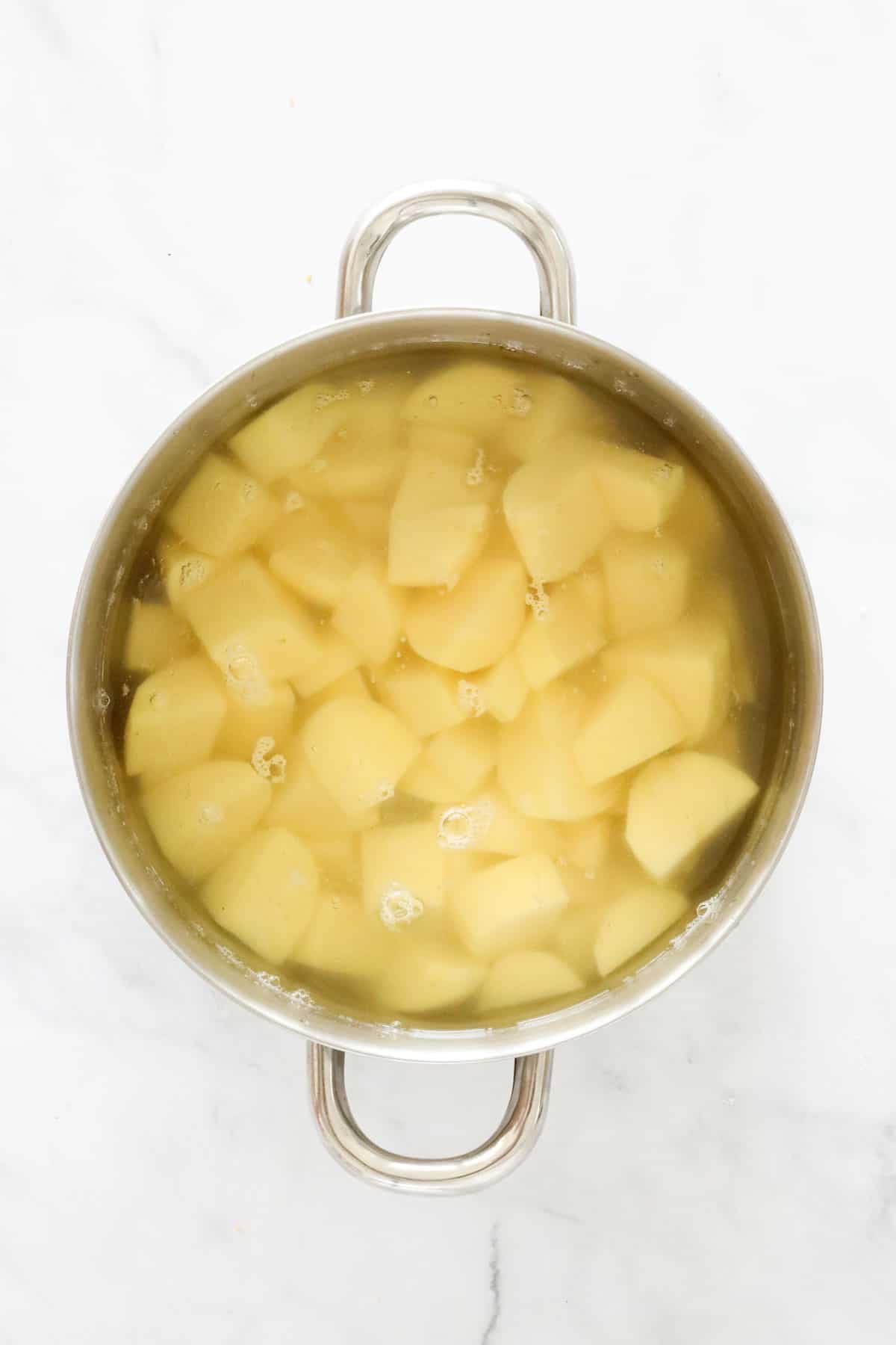 Potatoes and water in a pot.